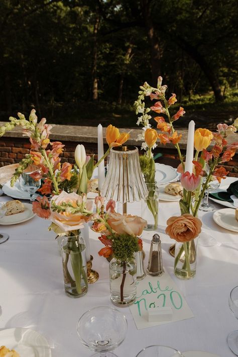 This bride and groom had a garden wedding theme, and for their guest centerpieces they used pastel floral budvases, mini lamps, and taper candles. The bride and groom also added in charger plates, napkins, and watercolor table numbers to each table. Anastasia Wedding, Candy Salad, Bride Era, Wedding Centerpiece Ideas, Quilted Robe, Photography Details, Champagne Problems, Garden Theme Wedding, Secret Garden Wedding