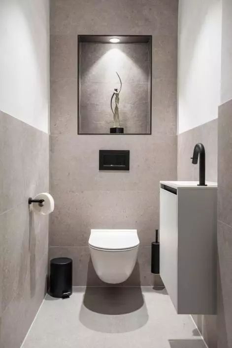 a neutral contemporary powder room clad with large scale greige tiles, with a floating vanity and black touches Small Toilet Design Modern, Small Toilet Room Decor, Modern Toilet Room, Small Toilet Ideas, Small Wc, Toilet Inspiration, Wc Inspiration, Modern Toilets, Toilet Interior