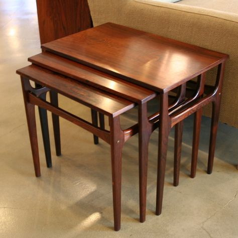 Beautiful set of 3 rosewood nesting tables. Finely carved solid rosewood tapering legs joined by the slightly hyperbolic curve of the cross beams. Elegant tables that can function as 3 matching pieces or compact into each other when more floor space is needed. Made in Denmark.  Dimensions: 21.5" x 13.5" x 18.5" h Designer: N/A Price: $895.00 | Sale: $765.00 Item #: 960-1 Nest Of Tables, Nesting Tables, Floor Space, Elegant Table, The Cross, Side Tables, Denmark, Beams, Side Table