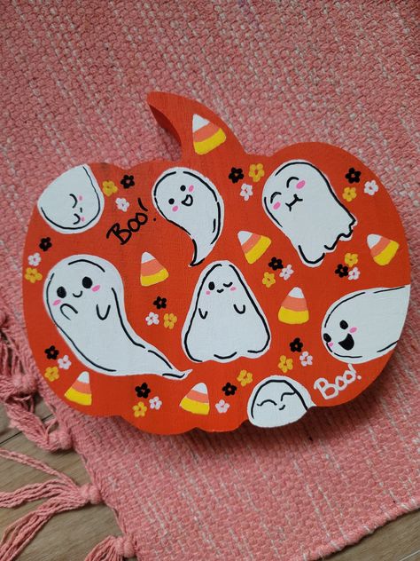 A cute ghosty painting done on a pumpkin shaped wood block! Great for Halloween decor and its thick enough to stand up on its own on a shelf or mantel :) Cute Wood Pumpkin Painting Ideas, Cardboard Pumpkin Painting, Halloween Wood Pumpkins Painted, Wooden Pumpkin Designs, Painting Wood Pumpkin Ideas, Painting Wooden Pumpkins Ideas, Pumpkin Wood Painting, Pumpkin Painting Craft, Ghost Painting On Wood