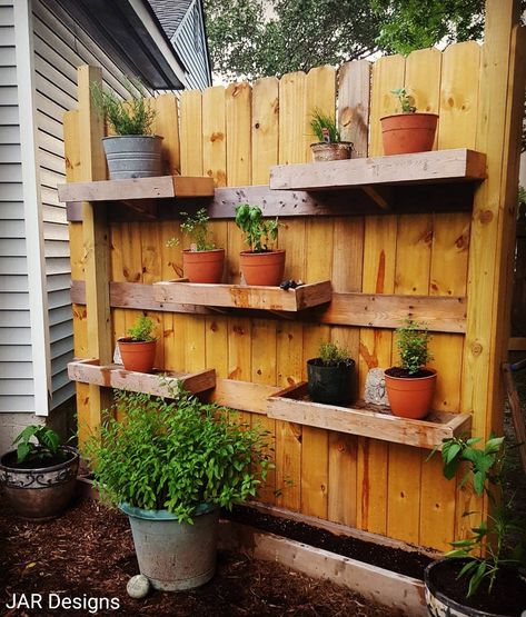 If you don't have a lot of space for gardening or pots, try building shelves on the back side of a fence. By doing this, I was able to have all my favorite herbs within an arms reach. Make sure to stagger your shelves for easy watering. Garden Fence Shelves, Outdoor Wall Herb Garden Ideas, Outdoor Fence Shelves, Shelves On Fence, Fence Flower Pots, Diy Fence Planters, Garden Wall Shelves, Garden Shelves Outdoor, Fence Shelves