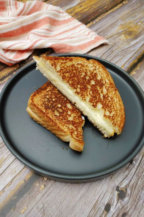 Grilled cheese sandwiches are a timeless classic that never goes out of style. There's something about the warm, gooey, cheesy goodness sandwiched between two slices of crispy bread that makes it a comforting and satisfying meal. Whether enjoyed on its own or paired with a bowl of tomato soup, grilled cheese is a staple in many households. This easy-to-make sandwich is perfect for a quick lunch, a lazy weekend brunch, or even as a midnight snack. Soup Grilled Cheese, Tomato Soup Grilled Cheese, Grilled Ham And Cheese, Crispy Bread, Making Grilled Cheese, Muenster Cheese, Classic Grilled Cheese, Grilled Ham, Grilled Cheese Sandwiches