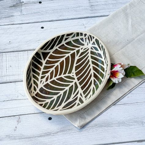 "Dream Platter.  I love this one! So simple, yet the carving turned out almost hypnotic as you follow the leaf design.  The glaze is actually a dark brown with shades and streaks of deep green hidden beneath.  I think it lends itself to slices of lemon or other bright fruits, sliced strawberries?  A set of these is in the making for a seafood lover! Porcelain 10 3/4\"L  X  8 1/4\"W Dishwasher and microwave safe All my pottery is hand thrown or hand built by me:)  This is my passion! and Therapy: Sgraffito Pottery Pattern Ideas, Sgraffito Designs Plates, Sliced Strawberries, Pottery Patterns, Ceramic Platter, Pottery Platter, Ceramic Platters, Ceramic Dinnerware, Ceramics Pottery Art