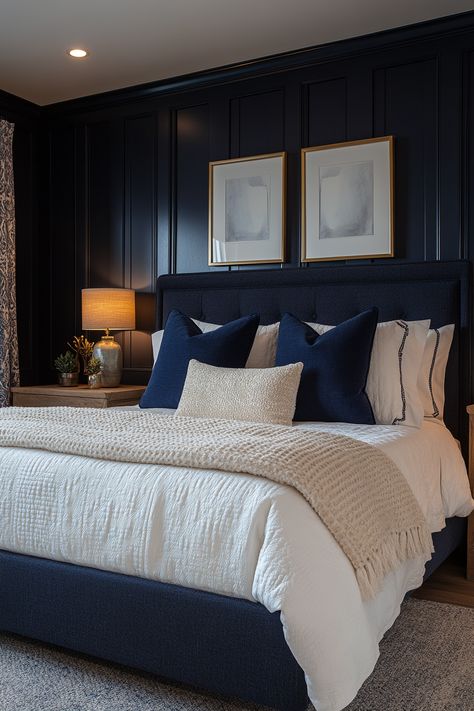 Create a cozy and chic navy blue and gold bedroom with these 29 stunning ideas.  Explore the versatility of this color combination to create a space that feels both inviting and luxurious.  Discover stunning decor ideas like navy velvet headboards, gold-framed mirrors, and brass light fixtures.  Add navy and gold throw pillows, gold geometric wall art, and plush navy carpets for a cozy and stylish bedroom oasis. Blue And Brass Bedroom, Navy Spare Bedroom, Navy Bed Decor, Midnight Blue Room Decor, Bedroom Navy Headboard, Dark Navy Master Bedrooms Decor, Bedrooms With Navy Accent Wall, Navy Blue Wall Bedroom Ideas, Navy Blue House Interior