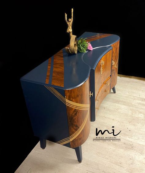 Introducing Monty he’s fine fella with a lot of love to give! Having come to Myriad Interiors in a sorry state he’s now a fine example of a Beautility Drinks Cabinet. Midnight blue a rich deep navy was chosen as his main colour with gold chevron detailing on his doors which wraps slightly around his sides. On his top matching chevrons of bare wood were left to pull his outfit together. Gold leaf was added to his support strut below to really give him the wow factor. As his original hardware Upcycled Sideboard, Drinks Cabinets, Bar Sideboard, Walnut Art, Mid Century Modern Art Deco, Stag Furniture, Sideboard Upcycle, Vintage Drinks, Art Deco Cocktail