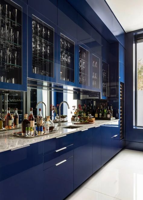 This oversized bar leaves quite the impression. Featuring a custom, high gloss, floor-to-ceiling blue lacquer with integrated refrigerator drawers, an ice maker, and a wine cooler.⁠ ⁠ High Gloss Blue Kitchen Cabinets, Modern High Gloss Kitchen, Navy Kitchen Cabinets, Dojo Design, High Gloss Kitchen Cabinets, Bar Library, Gloss Kitchen Cabinets, Bar Pantry, Integrated Refrigerator