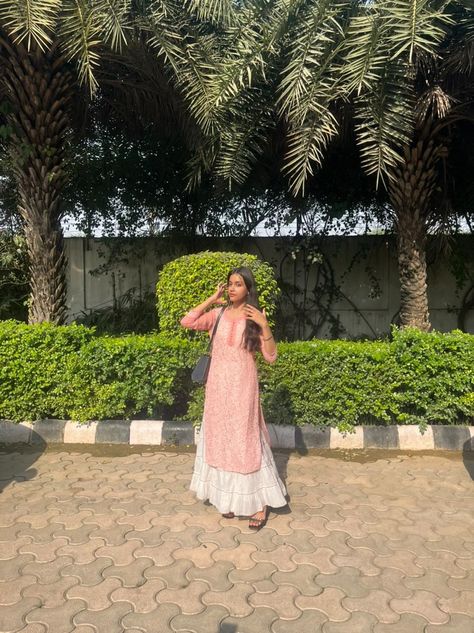 A girl wearing pink chicken kurti with white sharara, standing in the sun and posing candid. Pink Chicken Kurti, White Plazo, White Sharara, Chicken Kari, Pink Kurti, White Chicken, Boutique Dress Designs, Boutique Dress, Pink Shirt