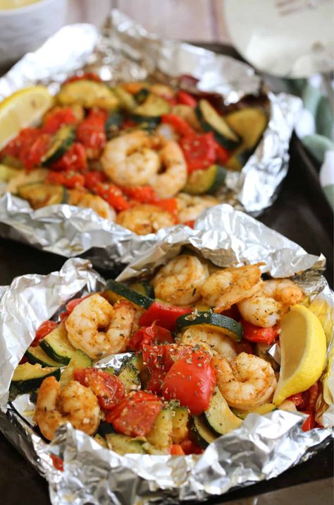 These easy GRILLED SHRIMP FOIL PACKS are loaded with shrimp, zucchini, peppers, tomatoes and tasty spices. Made on the BBQ or oven, cleanup is a breeze! #foilpack #shrimp #grilledshrimp #bbqshrimp #foilpackrecipe Shrimp Foil Packets For The Grill, Grilled Shrimp And Veggies, Shrimp Foil Pack, Shrimp Foil Packets Oven, Shrimp Foil Packs, Shrimp Zucchini Recipes, Easy Grilled Shrimp Recipes, Shrimp Zucchini, Foil Dinners