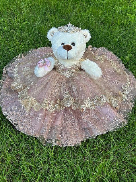 Ideal bear for your quinceanera party, it measures approximately 17" Each dress of our bears is custom designed matching the tone to the color of your quinceanera dress. It is worth mentioning that the tone of the fabric may vary, as well as the accessories (crown, earrings or necklace) If you need a more personalized bear or the same as your dress, it can also be made. Our specialty is satisfying our clients. You can contact us if you require a custom design. Contact: 817-443-7252 FB: Norma Vazquez Fashion Designer https://www.facebook.com/profile.php?id=100077462744454 Quince Bear Pink, Big Quinceanera Dresses, Quinceanera Ideas Pink, Quince Doll, Quinceanera Teddy Bear, Quinceanera Dances, Rose Gold Quince, Hispanic Jokes, Quinceanera Pink