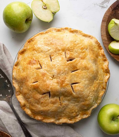 Bourbon Apple Pie is a sophisticated twist to the classic dessert, made with bourbon-infused apples in a flaky, golden crust. Enjoy a slice of this pie, and you'll savor the perfect blend of sweet, tart, and warm flavors with every bite! Vegan Apple Pie Recipe, Bourbon Apple Pie, Paleo Apple Pie, Old Fashioned Apple Pie, Traditional Apple Pie, Vegan Apple Pie, A Couple Cooks, Classic Apple Pie, Vegan Apple