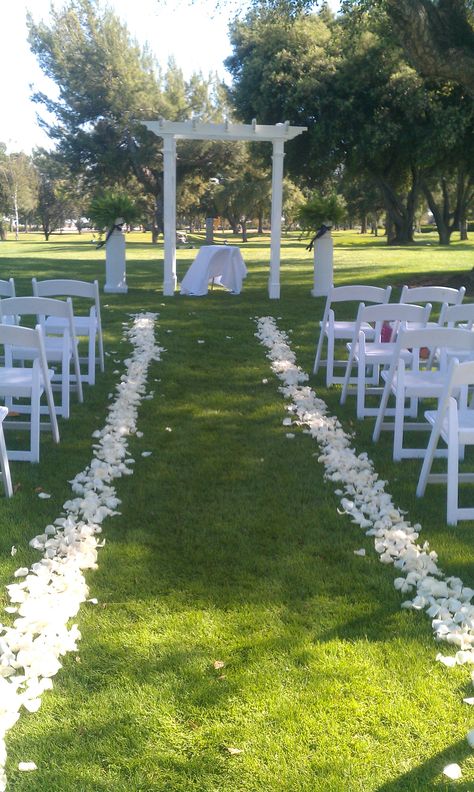 white rose petals down the aisle, awaiting the bride. Aisle Lined With Petals, Flower Petals Lining Wedding Aisle, Rose Petal Wedding Aisle, Walking Down The Aisle Decoration, Rose Petals Down Aisle, Rose Petal Walkway, Wedding Aisle Petals, Petals Down The Aisle, Arctic Flowers