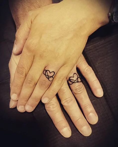 60 Best Love Tattoos that will Definitely Melt Your Heart in 2021 Infinity Ring Tattoos, Heart Ring Tattoo, Ehe Tattoo, Infinity Ring Tattoo, Wedding Ring Finger Tattoos, Wedding Ring Tattoos, Heart With Infinity Tattoo, Heart Tattoo On Finger, Infinity Couple Tattoos