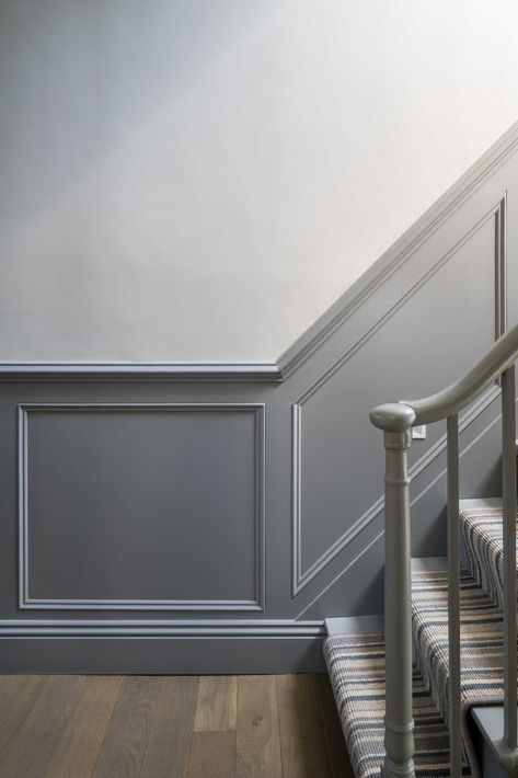 A staircase was updated with grey panelling and new carpet. Hallway Wall Colors, Staircase Paneling, Terrace Home, Wall Molding Design, Stair Paneling, Gray Stairs, Entryway Stairs, Wall Moulding, Traditional Staircase