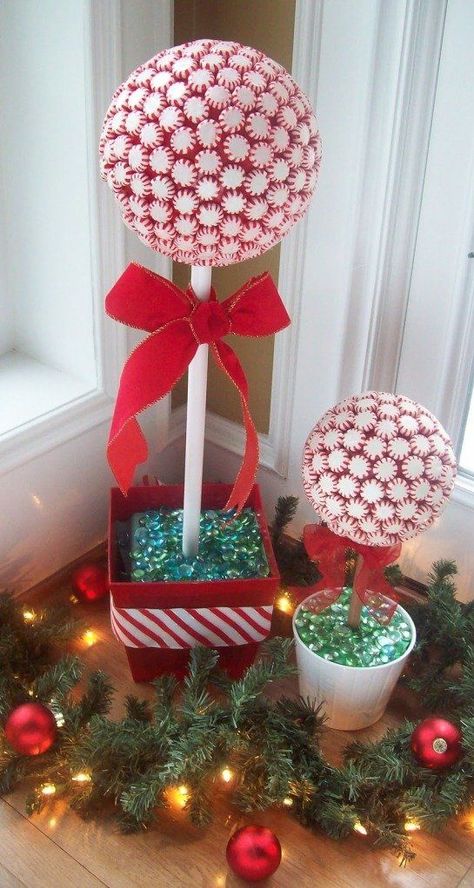 Decorating with candy is always so much fun — and cheap! Grab some peppermints, a styrofoam ball, and a flower pot and get crafting for the holidays. Use a long cinnamon stick or wrap the wooden dowel that will support the topiary with ribbon for a more festive look. Candy Topiary, Topiary Diy, Navidad Diy, Topiaries, Peppermint Candy, Noel Christmas, Handmade Holiday, Holiday Projects, Candy Canes