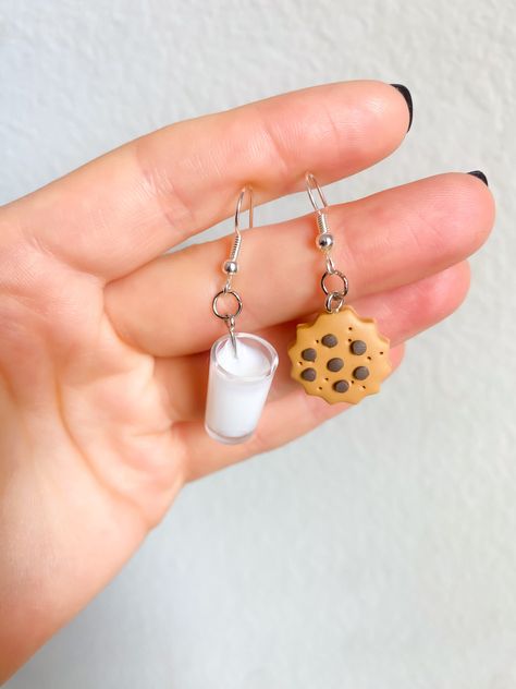 Santas Milk and Cookies Earrings, Chocolate Chip Cookie Dangle Earrings, Christmas Cocoa And Cookie Earrings, Stocking Stuffer for Her 🥛🍪The most wanted, most loved, OG MILK AND COOKIES earrings. These earrings are perfect for Christmas with the fam, Holiday season, office parties, and everyday wear! Your grandma will LOVE these! 🔗Hypoallergenic Silver Stainless Steel  🎁1/2 in. Pendants: Milk🥛: White Resin, Cookie🍪: Polymer Clay 🎅🤶I carefully package individual items with my original jewelry cards and packaging, and I am happy to write a handwritten gift message for you if the occasion calls for it. Please simply leave me your instructions in the note section at checkout. 🎄For more Christmas Jewelry items, click here! https://www.etsy.com/shop/LittleVineGrowery?section_id=45167461 Clay Earrings Cute, Christmas Cocoa, Cookie Earrings, Stocking Stuffers For Her, Jewelry Cards, Milk And Cookies, Milk N Cookies, Secret Santa Gift, Earrings Christmas