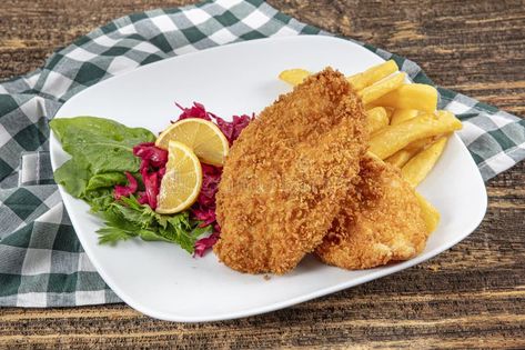 Fried sliced chicken schnitzel on a wooden board. Delicious crispy chicken fillet in breadcrumbs, close-up stock images Chicken Fillet, Chicken Schnitzel, Crispy Chicken, Wooden Board, Bread Crumbs, Appetizer, Grilling, Close Up, Sauce