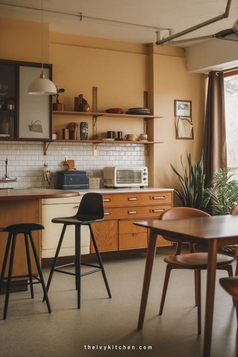 Cozy kitchen with wooden cabinets, plants, and modern bar stools. Eclectic Minimalist Kitchen, Kitchen Dining Ideas, Ivy Kitchen, Retro Modern Kitchen, Midcentury Modern Kitchen, Mid Century Modern Kitchen Design, Mid Century Modern Cabinets, Eclectic Minimalist, Modern Kitchen Dining