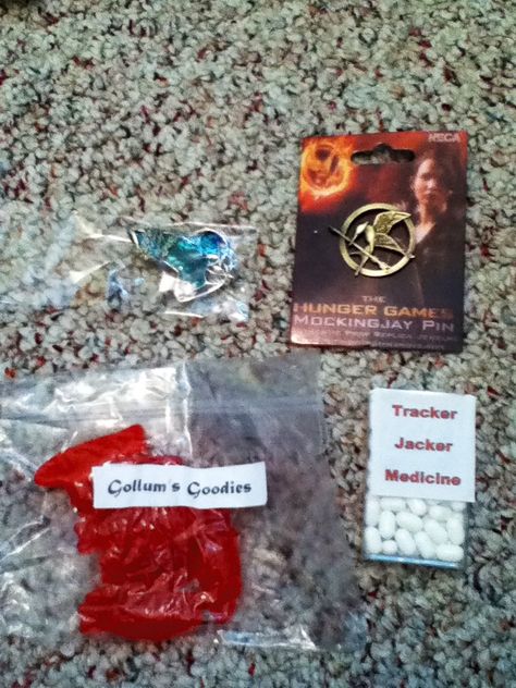 Party favors for Lord of the Rings and Hunger Games. Guests would chose a bag with either the LOTR or Hunger Games picture. From their pick, they would either receive the mockingjay pin or the elven leaf. Both type of bags would receive the goodies: sweedish fish as Gollum’s goodies and tracker jacket medicine (tic tacs) Hunger Games Jewelry, Mockingjay Pin, The Mockingjay, Game Pictures, Blind Bags, Mockingjay, Types Of Bag, The Rings, Lord Of The Rings