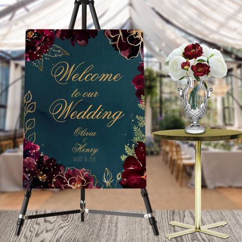 A teal blue jewel tone "Welcome To Our Wedding," wedding foam core poster sign featuring a symphony of deep bordeaux raspberry red peonies embellished with gold spray and shimmering gold outlines gather around a deep teal blue watercolor-wash background with your names in a rustic lively gold wedding script. Jewel Tone Wedding Decor, Jewel Tone Wedding Theme, Jewel Tone Decor, Raspberry Wedding, Purple And Gold Wedding, Wedding Script, Maroon Wedding, Jewel Tone Wedding, Jewel Wedding