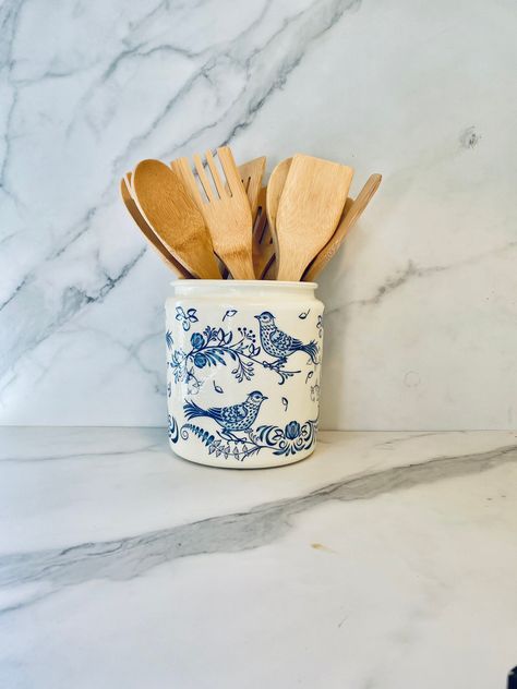 "This blue chinoiserie, utensil holder is a 64 ounce, 1/2 gallon, 7\"H x 6\"W glass jar decoupaged with a bluebird themed napkin and coated with a gloss sealant   The background is an off-white.  I also offer free shipping)" Blue And White Utensil Holder, Apt Decor, Utensil Caddy, Blue Kitchen Decor, Pure White Background, Blue Chinoiserie, Utensil Crock, Kitchen Utensil Holder, French Country Farmhouse