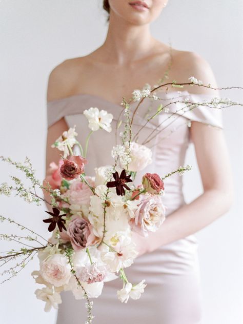 "S" Shape Created by Jules and Pearls Events, this cosmo, Japanese anemone, garden rose, and carnation spray was structured by winding in-bloom branches. #modern #bouquet #flowers #structured #minimalist Nontraditional Bride, Modern Wedding Bouquets, Champagne Color Dress, Modern Bouquet, Blush Bouquet, Wedding Bouquets Bride, Bride Bouquets, Bridal Flowers, Blush Wedding