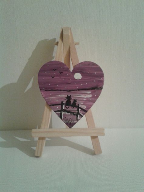 Cat silhouette on a fence painted on wooden heart Painting On Heart Shaped Wood, Painting On A Heart Shape Canvas, Heart Wood Painting, Painted Wood Hearts, Painting On Heart Shaped Canvas, Heart Shaped Painting, Painted Hearts On Wood, Wooden Heart Painting Ideas, Heart Shaped Canvas Painting Ideas