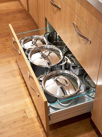 Drawers and Pullouts  In One Place  A large drawer like this one is designed to store plenty of bulky cooking gear, a logical place to organize and store your hardest-working pots and pans. Under Cooktop Drawers, Pot Organization Inside Drawer, Under Stove Storage Drawer, Pot Drawer, Countertop Stove, Pan Storage, Pot Storage, Wood Pots, Drawer Glides