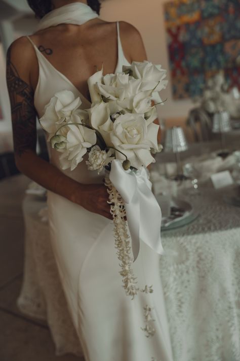 Elegant and minimal bridal bouquet featuring classic white roses, accented with a delicate ribbon and cascading florals. Perfect for brides embracing modern simplicity with a touch of romance. Cascading Floral Bouquet, Modern Cascade Bouquet, Old Money Wedding Bouquet, Minimal Bridal Bouquet, White Cascade Bouquet, Minimalist Bridal Bouquet, Bridal Bouquet Cascading, February Flower, Modern Bridal Bouquets