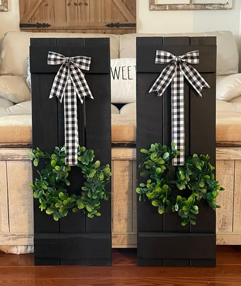 Farmhouse Wood Shutter Wall Decor, complete with charming Buffalo Check Wreath.  Each piece measures 30" x 10.5" and can be purchased separately.  Create a stunning focal point in any room with this rustic and elegant decor set. The farmhouse wood shutters add a touch of vintage charm, while the buffalo check wreaths bring a pop of colour and pattern.  Hanging hardware is included on the back.  Measurements may vary up to one inch. Shutters Inside Decor, Shutter Display Ideas, Holiday Shutter Ideas, Wood Shutter Craft Ideas, Using Shutters As Wall Decor, Things To Do With Old Shutters, Farmhouse Door Decor, Dollar Tree Picket Fence Crafts, Shutter Christmas Decor