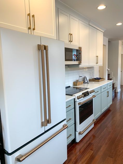 Create a wow-worthy kitchen in just a matter of days! The subtle two-toned cabinets and gold hardware complement the modern matte white cafe appliances completely transformed this previously dated kitchen. White And Gold Appliances Kitchen, Matte White Appliances Kitchen, Appliance Colors, Best Appliance Color For White Kitchen, Cafe Fridge, Cafe Matte White Appliances With Wood Cabinets, Gold Kitchen Appliances, Painted Kitchen Appliances, White And Gold Kitchen Appliances