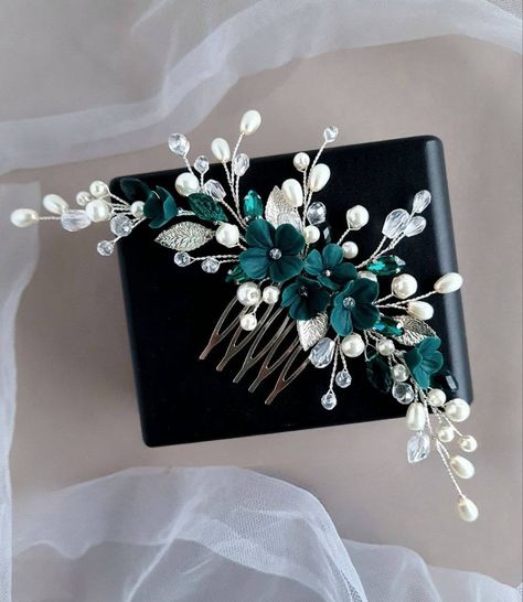 Elevate your special occasion look with this exquisite handmade emerald hair comb featuring delicate polymer clay flowers, crystal rhinestones, and lustrous pearl beads. Each element is meticulously crafted and assembled with care, creating a stunning accessory that exudes elegance.     * Materials: Polymer clay flowers, crystal rhinestones, crystal and pearl beads, metal leaves, and jewelry wire.     * Length: Hair comb - approximately 6.5 inches     * Earrings: Approximately 3 inches long     * Bracelet: Length can be personalized (please provide desired length in the notes at checkout)     This emerald hair comb is the perfect addition to adorn your hair for weddings, proms, or any special event where you want to make a statement. Its timeless design and vibrant emerald hue will complem Green Emerald Flower Jewelry, Emerald Green Hair Accessories, Emerald Green Bridal Hair Accessories, Green Hair Piece, Emerald Hair Piece, Teal Hair Accessories, Emerald Hair Pin, Teal Wedding Flowers, Green Wedding Jewelry