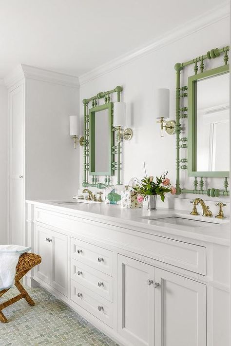 Mint green basketweave floor tiles lead to a white dual bath vanity fitted with polished brass vintage style faucets mounted beneath green abacus style mirrors hung from a white wall between brass and glass sconces. Cottage Lake House, Transitional Coastal, Cottage Lake, Pool Bath, White Subway Tiles, Cottage Bathroom, Traditional Cabinets, Coastal Bathrooms, House Beach