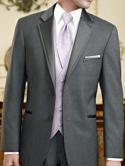 Gray/lavender tuxedo Black Suit Grey Vest Wedding, Grey And Lavender Tuxedo Wedding, Black Suit With Lilac Tie, Gray Tuxedo Prom, Purple Prom Tux, Lavender Tuxedo, Quinceanera Chambelanes Outfits, Dark Grey Groomsmen, Prom Tuxedo Ideas