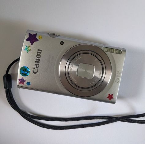 Canon Aesthetic Camera, Aesthetic Canon Camera, Old Canon Camera, Stickers On Camera Aesthetic, Canon Mini Camera, Digital Camera Aesthetic Stickers, Small Camera Aesthetic, Vintage Canon Camera, Camera With Stickers Aesthetic