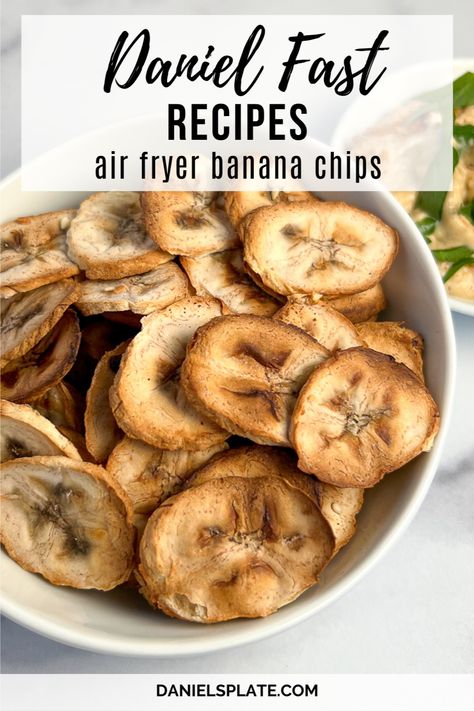 Are you doing the Daniel Fast? These savory air fryer banana chips are made with unripe green bananas. Pair this fast and easy one-ingredient snack with hummus or a big bowl of veggie chili. This chip is oil-free, soy-free, nut-free, gluten-free, vegan, and low-fat. Check out this and other Daniel Fast recipes here... How To Dehydrate Bananas, Air Fryer Banana Chips, Dehydrate Bananas, Daniel Fast Snacks, Dehydrated Banana Chips, Homemade Banana Chips, Air Fryer Banana, Dehydrated Bananas, The Daniel Fast