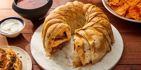 This impressive-looking taco ring is made with flour tortillas encasing a filling of spiced ground beef, two kinds of cheese, and Doritos. Serve with salsa and sour cream. Taco Ring, Creamed Beef, Beef Dinners, 2024 Recipes, Protein Nutrition, Kinds Of Cheese, Mexican Foods, Hearty Dinner, Pan Recipes