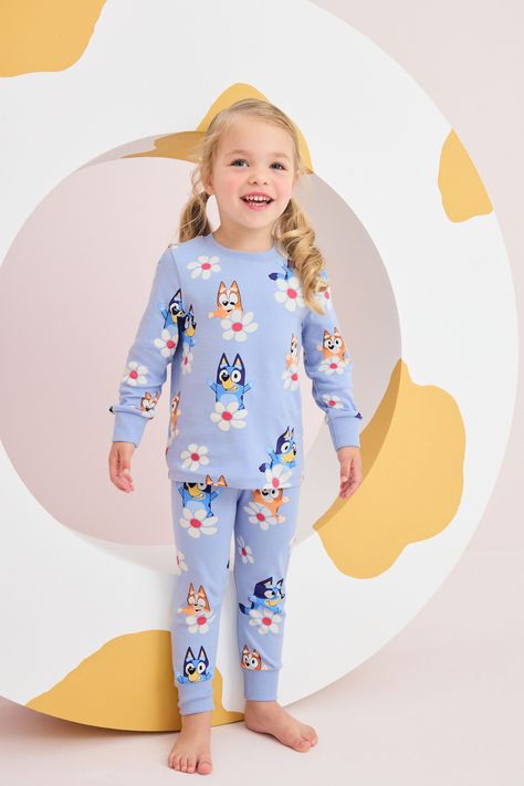 Add some character to their nightwear with our red/blue 2 pack of Bluey pyjamas. Made from pure cotton, this pack comprises of a red and blue pyjama set both with a long sleeve top and elasticated bottoms. Complete with a licensed Bluey print, embroidered detailing and ribbed hems. Machine washable. 2 x Pyjama Top and 2 x Pyjama Bottom 100% Cotton.