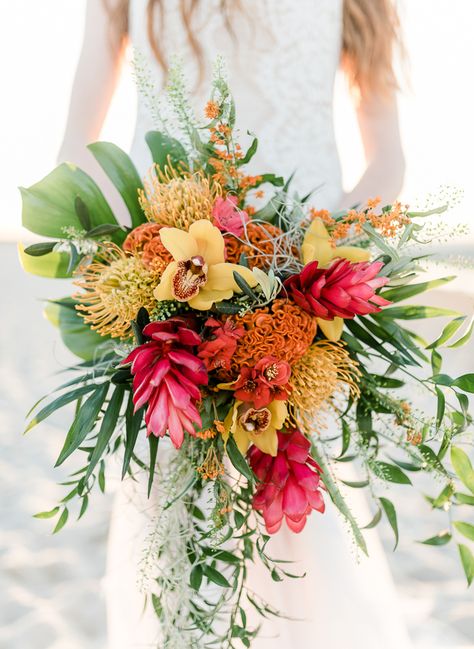 The romantic and relaxed setting among sand and sunshine makes a coastal wedding perfect for a destination wedding, elopement or vow renewal. Wedding invitations, cakes and bouquets can incorporate a tropical and classic colorful palette. The bride’s wedding gown and bridesmaids’ dresses look elegant in light and airy fabrics as silk chiffon or organza. Incorporating … Tropical Bridal Bouquet, Tropical Wedding Bouquets, Tropical Wedding Theme, Hawaii Beach Wedding, Tropical Wedding Inspiration, Tropical Beach Wedding, Bouquet Bride, Tropical Wedding Flowers, Tropical Bridal