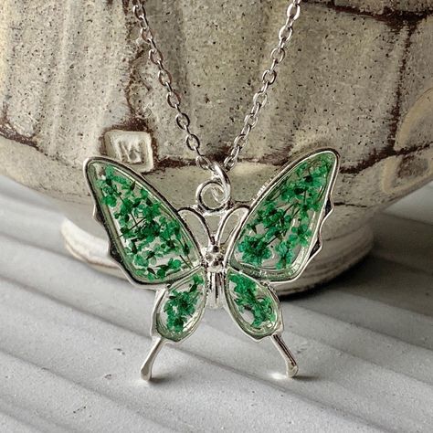 St. Patty’s Butterfly 🍀 🦋 - - - - - #cchenrydesigns #stpatricksday #greennecklace #queenanneslace #butterflynecklace #greenbutterfly #pressedflowerjewelry #pressedflower #driedflowers #resinart #resinjewelry #pressedflowerart #handmadejewelry Soul Loss, Pressed Flower Resin Jewelry, Spiritual Alchemy, Easter Necklace, Pressed Flower Resin, Flower Resin Jewelry, Silver Flower Necklace, Pressed Flower Necklace, Eco Resin