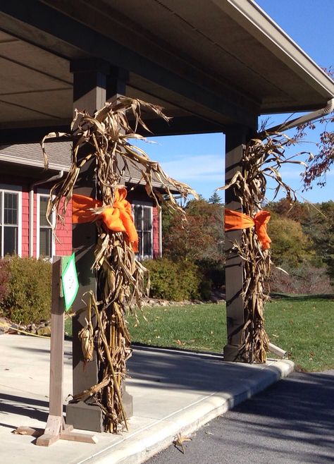 Tall corn stalks and orange burlap bows for fall columns Dried Corn Stalks Front Porch, Decorate With Corn Stalks, Fall Corn Stalk Decor, Corn Stalks Decorations Diy, Fall Hay Bale Display, Decorating With Corn Stalks, Corn Stalks Front Porch, Fall Hay Bale, Corn Stalks Decorations