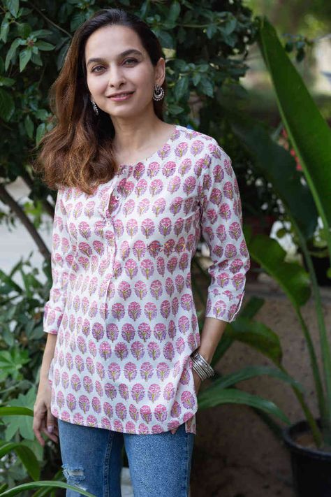 If you are looking for something light but professional, this shirt-style Kurti would be perfect for you. Made from 100% cotton, this Kurti lets you breathe, feels light and comfortable. And when it comes to the looks, the hand block print on pink is just magic to the eyes. The kurti comes with front buttons and round neck, pair this with our white cotton pants for perfect look or your denim Shirt Style Kurti, Short Kurti Designs, White Cotton Pants, Style Kurti, Just Magic, Short Kurti, Designer Outfits, Indian Designer Outfits, Hand Block Print