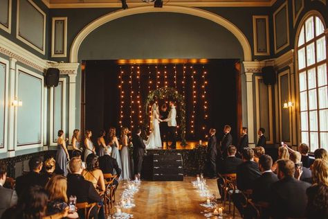 This intimate ceremony featured candles + string lights | Image by Magic Wedding Photographer Wedding In Theatre, Wedding In A Theatre, Theatre Wedding Ceremony, Theater Wedding Ceremony, Muppet Wedding, Wedding Theatre, Mahogany Room, Brighton Wedding, Hanging Flowers Wedding