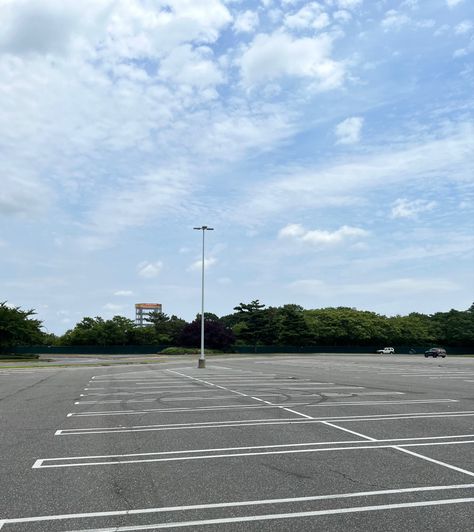 Almost empty parking lot with cloudy sky. Parking Lot Background, Sky Scape, Suburban Gothic, Empty Parking Lot, Background References, School Background, Learning To Drive, Car Lot, Title Sequence