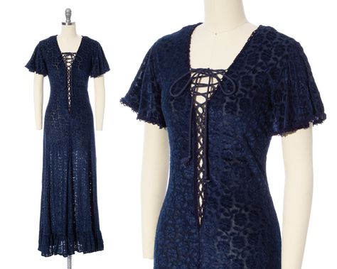 "♡ PLEASE ENLARGE PHOTOS FOR MORE DETAIL ♡ D E T A I L S * very early 1970s maxi dress - RARE! * hourglass shape * burnout velvet with a floral design * feels like a mix of cotton + rayon * gorgeous navy blue color * crochet trim * v-neckline * short flutter sleeves * plunging lace-up corset front; can be tied up as high or low as you want * very slight a-line shaped skirt * ruffled tier at hem of skirt * no other closures besides lace-up front * unlined + sheer; a slip is recommended * label: Jessica | Gunne Sax  M E A S U R E M E N T S fits like a: x-small | small shoulders: 15\" bust: adjustable | about 30-36\" waist: adjustable | about 26-28\" hips: 33-36\" length: 55\" sleeve length: 7\" C O N D I T I O N Very good vintage condition. Ready to wear! There was one very small hole on bac Patterned Dresses, Prairie Dresses, Sax Dress, Gunne Sax Dress, Blue Corset, Vintage Dress 70s, Lace Up Corset, Dress 70s, Burnout Velvet