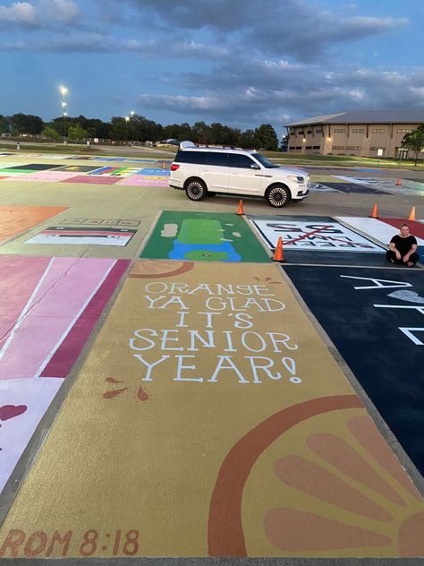 orange parking spot "orange ya glad it's senior year" romans 8:18 on bottom Group Parking Spot Ideas, Senior Parking Spot Album Cover, Highschool Parking Spot Ideas Funny, Marvel Senior Parking Spot, Funny Painted Parking Spots, Zach Bryan Parking Spot Painting, Disney Parking Spot Painting Ideas, Disney Senior Parking Spaces, Friends Parking Spot Painting