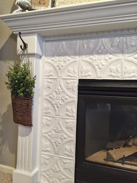 28 Beautiful Fireplace Tile Ideas to Refresh Your Home Old Fireplace Makeover Tile, White Fireplace With Tile, Tile Chimney Makeover, Tin Tiles Around Fireplace, Fireplace With Tiles Surround, Adhesive Tiles Fireplace, Electric Fireplace Ideas With Tv Modern Tile, Backsplash On Fireplace, Fireplace Facade Makeover