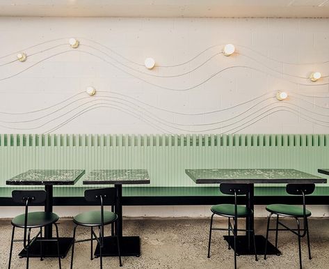 This modern restaurant design uses electrical conduit and keyless lamp fixtures to create attractive wall art that lightly traces the shape of a wave. Dark Restaurant, Eames Dining Chair, Vancouver Restaurants, Taco Restaurant, Modern Restaurant Design, Electrical Conduit, Water Station, Modern Restaurant, Interior Design Magazine