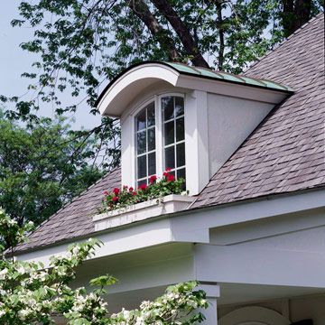 Arched Shed Dormer Window with Copper  The first inclination may be to cover a new dormer top with shingles used elsewhere on the roof, but it's an excellent chance to introduce a new material.  This arched shed dormer window is dressed up with copper roofing material to tie in with hardware found elsewhere on the exterior, and the window box was constructed to match ones gracing windows on the main level. Versetta Stone, Exterior Entrance, Dormer Roof, Dormer Window, Shed Dormer, Vinyl Exterior, Copper Roof, Dormer Windows, Stone Siding