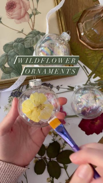 Stacey of GreenValleyGable 🌻 on Instagram: "After I saw Sunny @northwoodsfolk make dried flower ornaments, I had to give it a go! 🌸🌼🎄 Simply modge podge pressed flowers onto ornaments of your choice. My flowers were dried from our farm over the summer using a press J.R. built for me. Pearl sheen ornaments are from Walmart. If you would like to build a flower press of your own, I have a full tutorial on my blog. Greenvalleygable.com 🌿🌿 #driedflowers #pressedflowers #flowercraft #naturecraft Dried Flower Ornaments, Crib Spring, Build A Flower, Curtain Tutorial, Country Cottage Farmhouse, Vintage Crib, Cottagecore Christmas, Cottage Christmas, Modge Podge