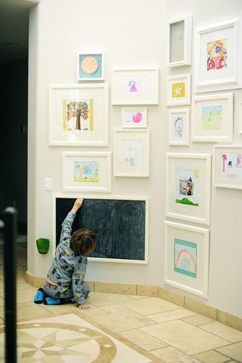 Pages marked up during kindergarten art class look surprisingly chic when displayed in a frame of honor. And we love how this mom added a childs-height chalkboard for spontaneous strikes of inspiration. See more at Shad and Lizzie » Displaying Childrens Artwork, Art Display Kids, Unique Gallery Wall, Childrens Artwork, Gallery Wall Living Room, Playroom Storage, Playroom Organization, Organization Inspiration, Kids Artwork